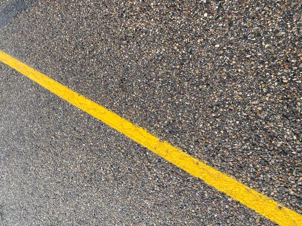 A yellow line on a roadway.